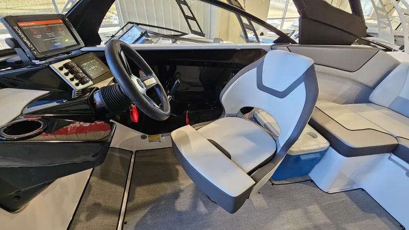 Slide: The Image of 2023 Yamaha Boats AR220 interior with modern helm, steering wheel, and seating. - 12