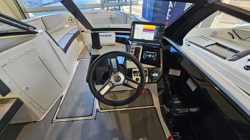Slide: The Image of 2023 Yamaha Boats AR220 cockpit with steering wheel and modern navigation system. - 14