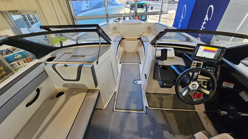 Slide: The Image of 2023 Yamaha Boats AR220 interior with modern dashboard and seating. - 16