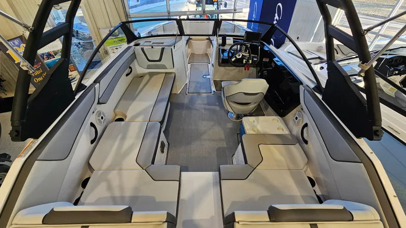 Slide: The Image of 2023 Yamaha Boats AR220 interior with spacious seating and modern helm design. - 7