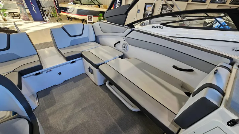 Slide: The Image of 2023 Yamaha Boats AR220 interior with spacious seating and modern design. - 9