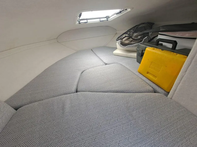 Slide: The Image of 2004 Glastron GS209 cabin interior with storage items and a small window. - 3