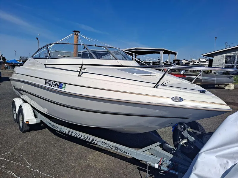 Slide: The Image of 2004 Glastron GS209 boat on trailer, parked outdoors under clear blue sky. - 5