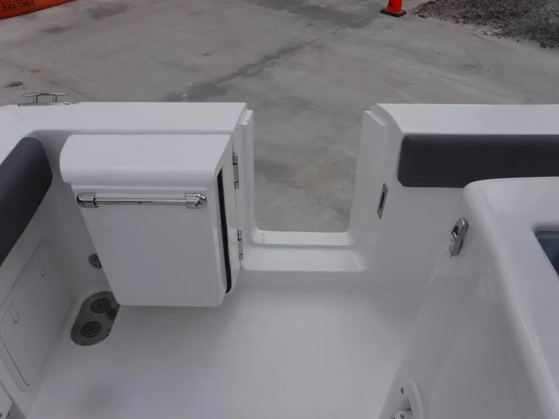 Slide: The Image of 2025 NauticStar 292 Legacy boat interior, featuring sleek white seating and storage compartments. - 10