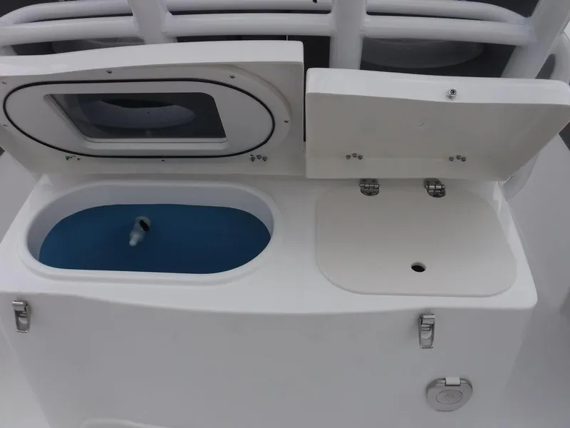 Slide: The Image of Open compartments on a 2025 NauticStar 292 Legacy boat, featuring storage and utility spaces. - 13