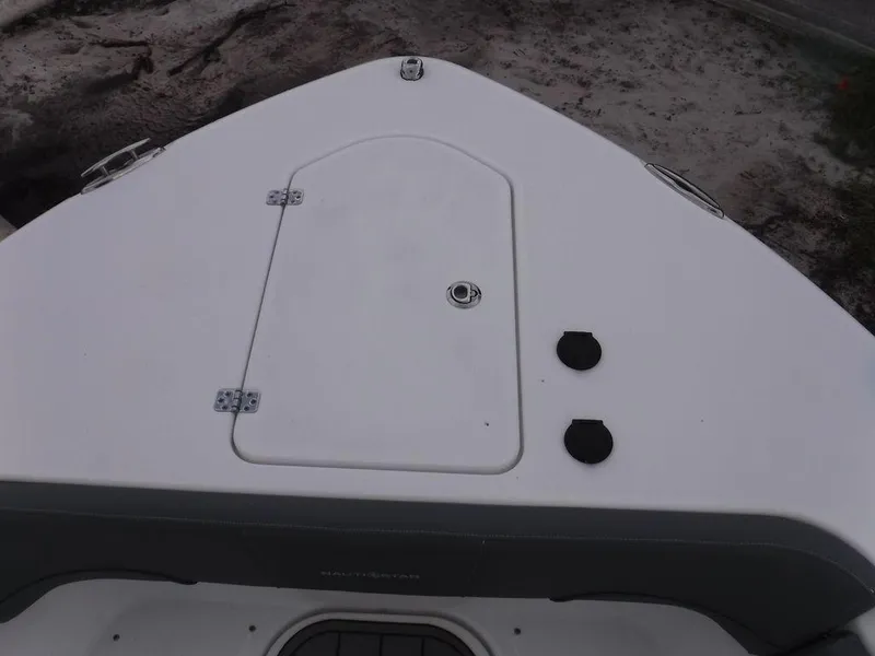 Slide: The Image of Bow view of 2025 NauticStar 292 Legacy boat, featuring storage hatch and fittings. - 18