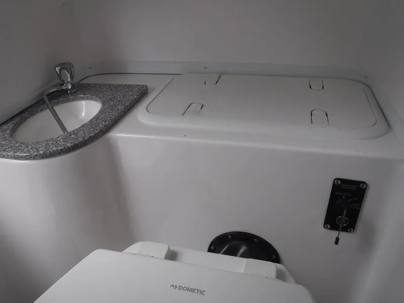 Slide: The Image of 2025 NauticStar 292 Legacy boat interior with sink and storage compartments. - 21