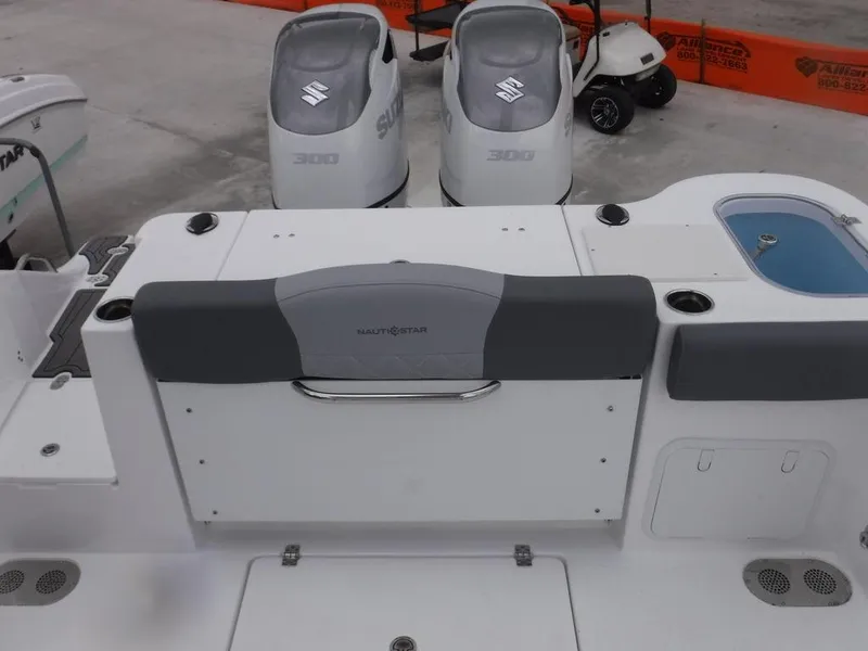 Slide: The Image of 2025 NauticStar 292 Legacy boat with dual Suzuki engines, rear seating, and storage compartments. - 5