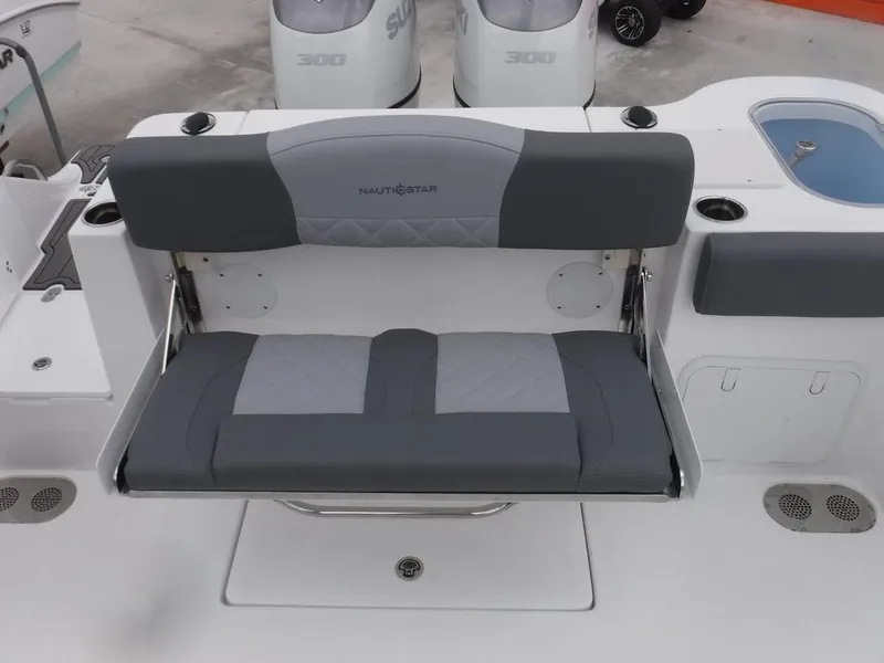 Slide: The Image of 2025 NauticStar 292 Legacy boat with gray cushioned seating and dual outboard motors. - 6