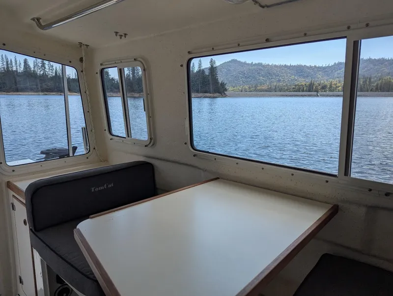 Slide: The Image of Interior of 2008 C-Dory 255 TOMCAT boat with scenic lake view through windows. - 22