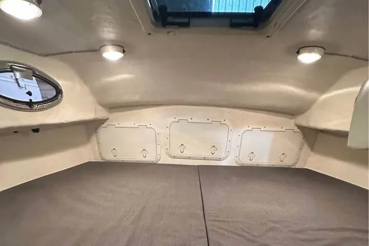 Slide: The Image of 2008 C-Dory 255 TOMCAT cabin interior with lighting and storage compartments. - 29