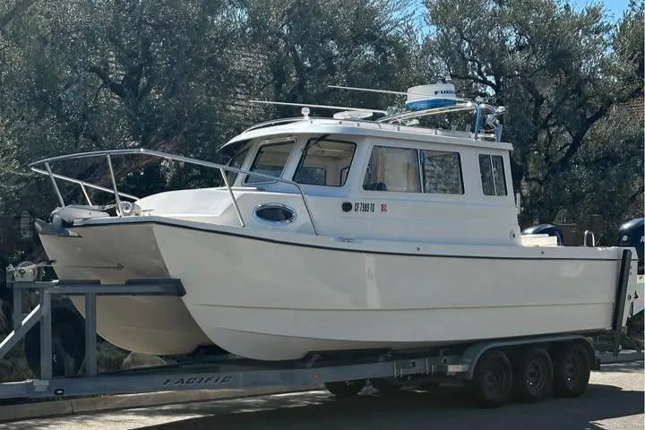 Slide: The Image of 2008 C-Dory 255 TOMCAT boat on trailer, parked outdoors. - 6