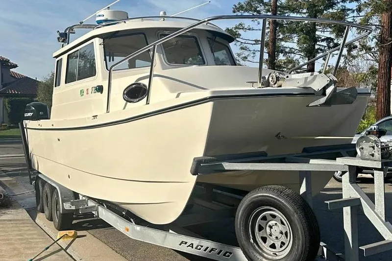Slide: The Image of 2008 C-Dory 255 TOMCAT boat on trailer, parked outdoors. - 8