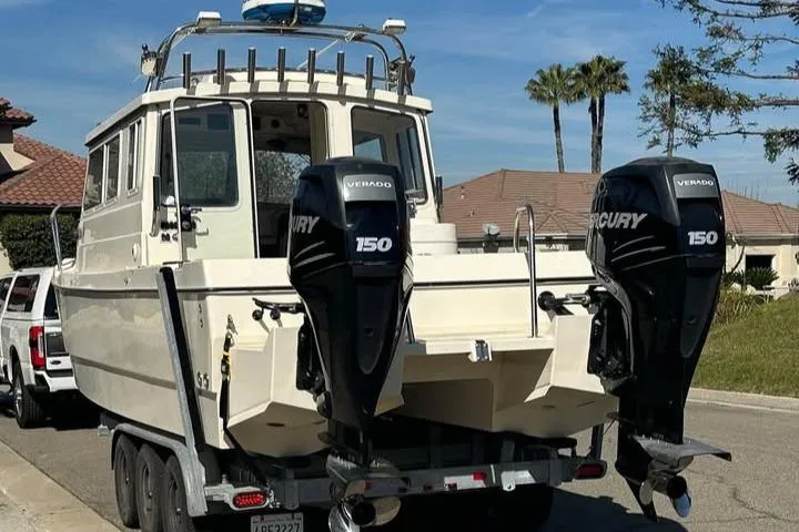 Slide: The Image of 2008 C-Dory 255 TOMCAT boat with dual Mercury 150 engines on a trailer. - 9