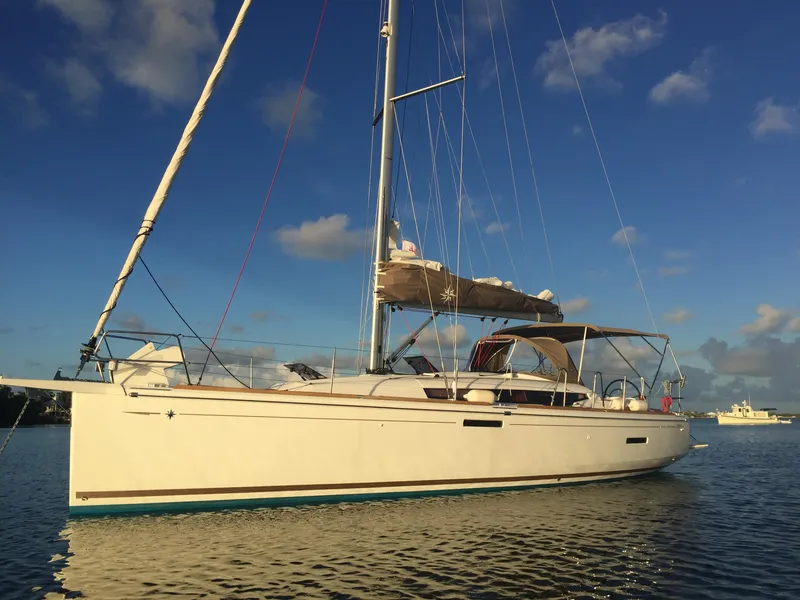Slide: The Image of 2017 Jeanneau Sun Odyssey 389 sailboat on calm water under a clear sky. - 0