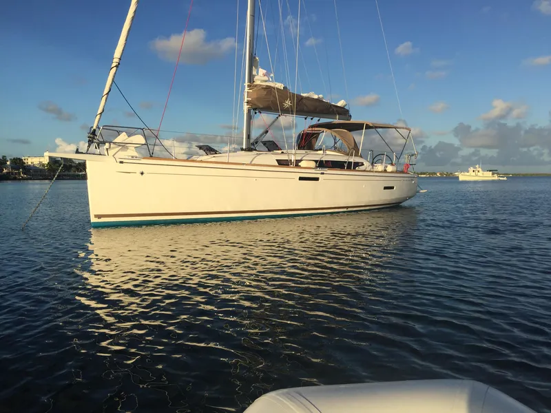 Slide: The Image of 2017 Jeanneau Sun Odyssey 389 sailboat on calm water under blue sky. - 1