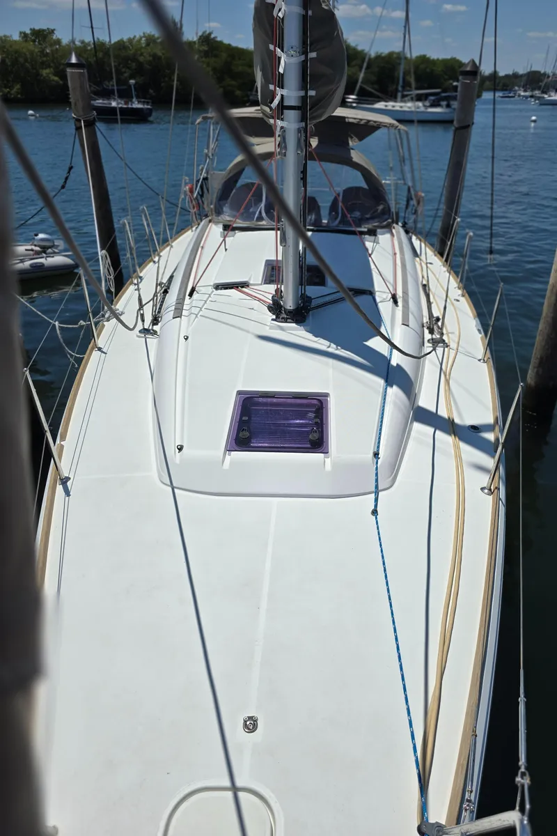 Slide: The Image of 2017 Jeanneau Sun Odyssey 389 sailboat docked, top view of deck and mast. - 12