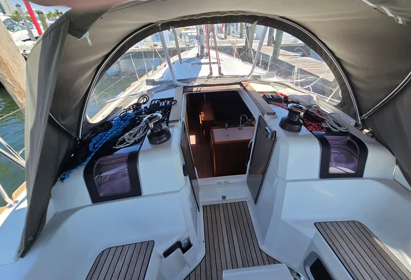 Slide: The Image of 2017 Jeanneau Sun Odyssey 389 cockpit with canopy, showcasing ropes and winches. - 16