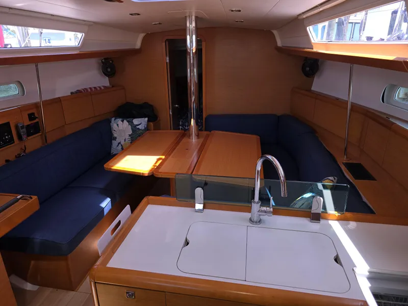 Slide: The Image of 2017 Jeanneau Sun Odyssey 389 interior with modern kitchen and cozy seating area. - 23