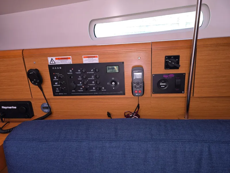 Slide: The Image of Control panel inside 2017 Jeanneau Sun Odyssey 389 sailboat, featuring navigation and communication equipment. - 24