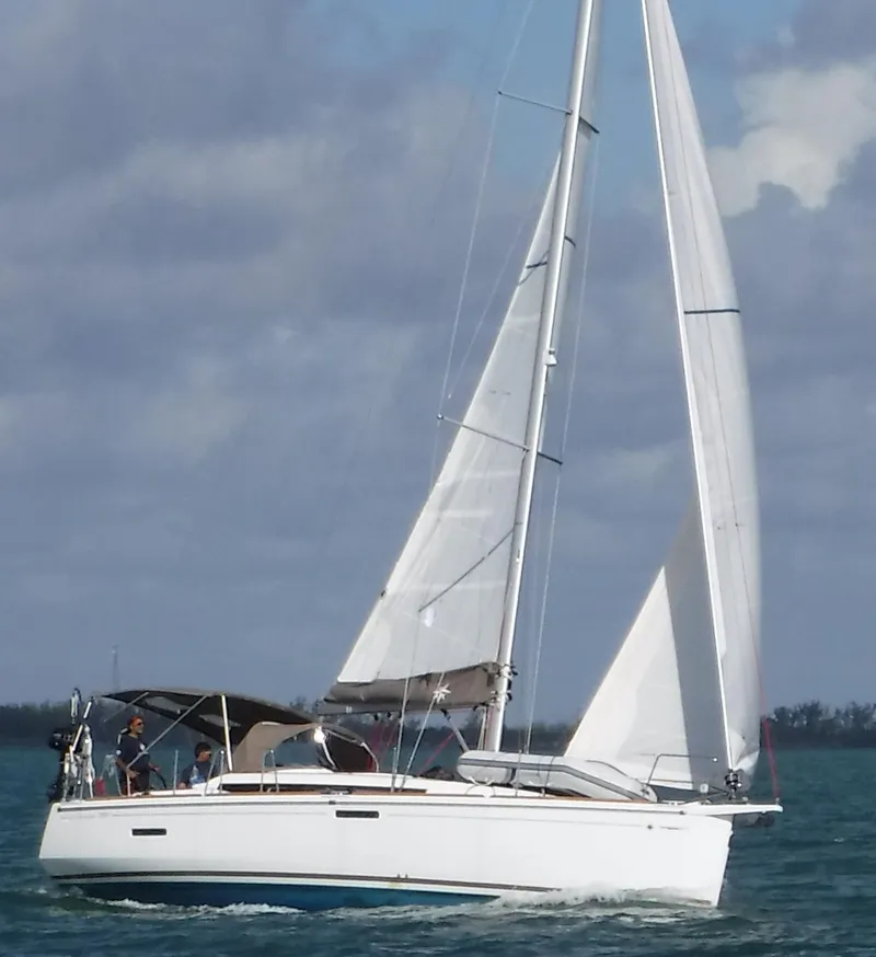 Slide: The Image of 2017 Jeanneau Sun Odyssey 389 sailing on open water under cloudy skies. - 4