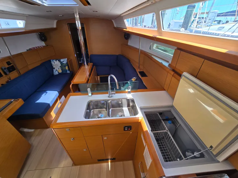 Slide: The Image of Interior of 2017 Jeanneau Sun Odyssey 389 sailboat with modern kitchen and seating area. - 47
