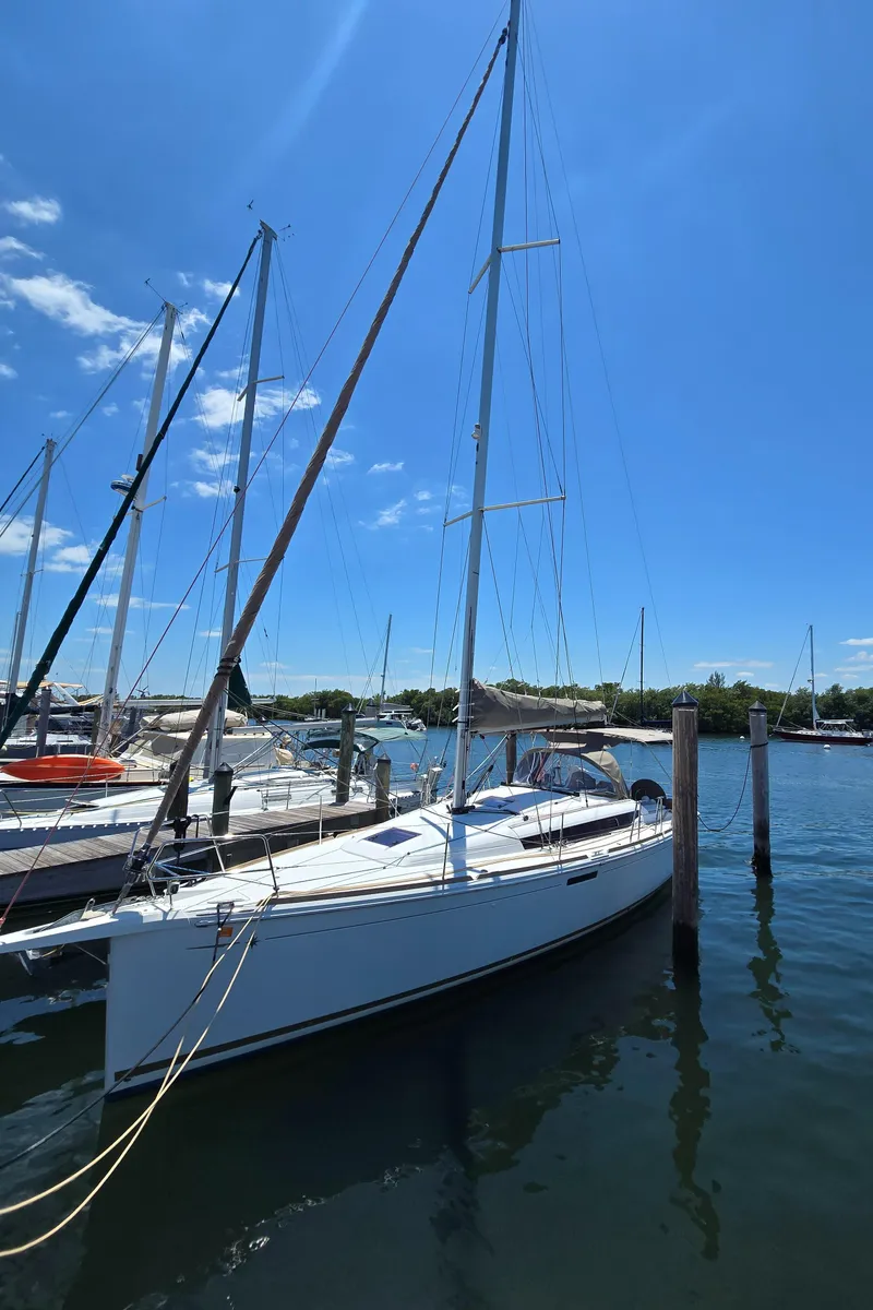 Slide: The Image of 2017 Jeanneau Sun Odyssey 389 sailboat docked under clear blue sky. - 9