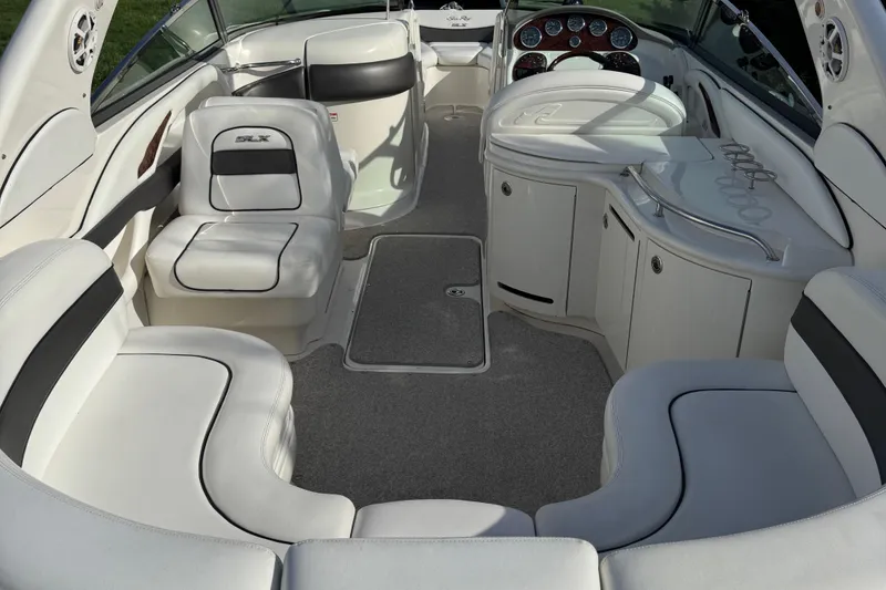 Slide: The Image of Interior of a 2006 Sea Ray 290 SLX boat with white seating and dashboard. - 10