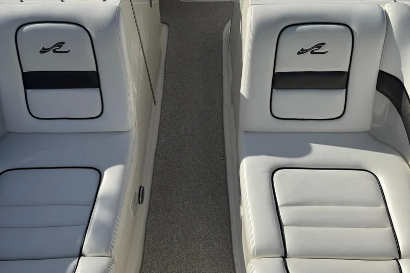 Slide: The Image of 2006 Sea Ray 290 SLX boat interior with white leather seats and logo. - 5