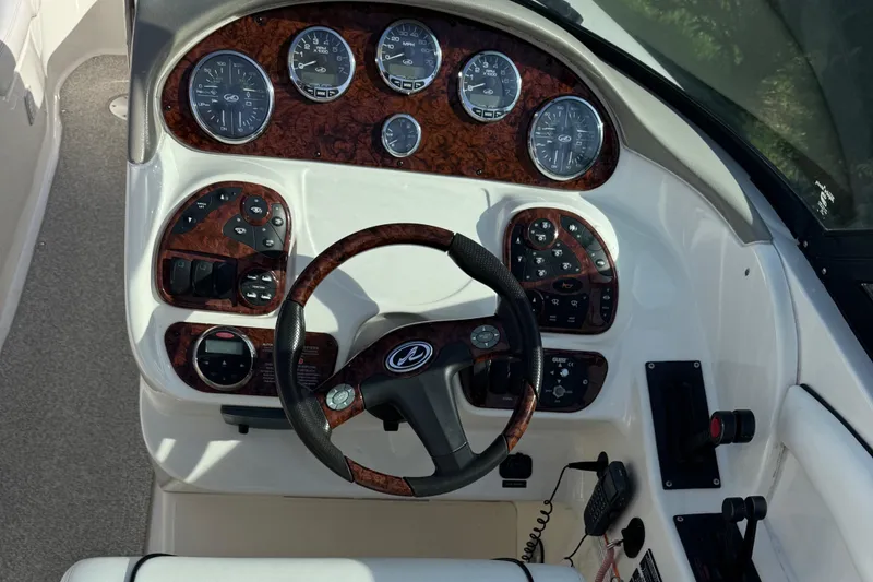 Slide: The Image of 2006 Sea Ray 290 SLX dashboard with gauges and steering wheel. - 6