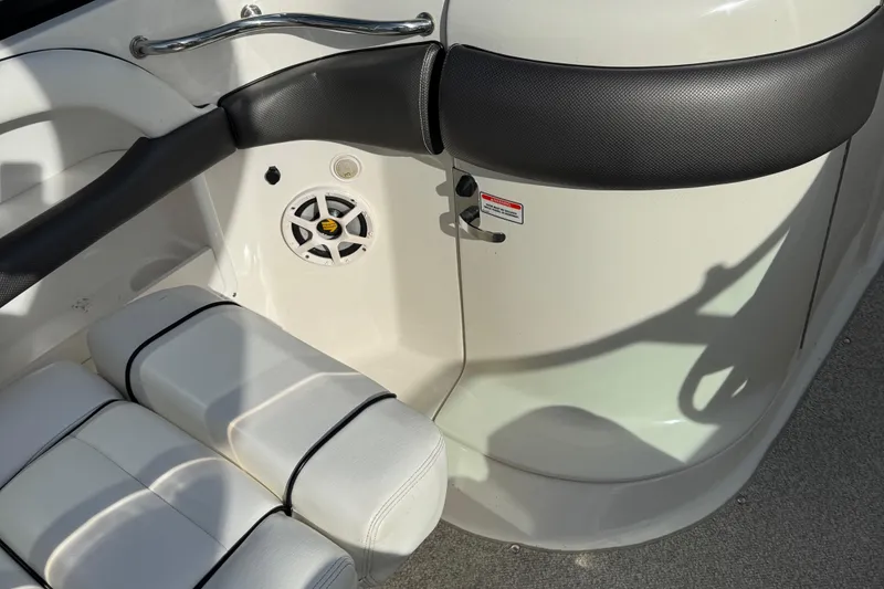 Slide: The Image of Interior of a 2006 Sea Ray 290 SLX boat, featuring white seating and speaker. - 9