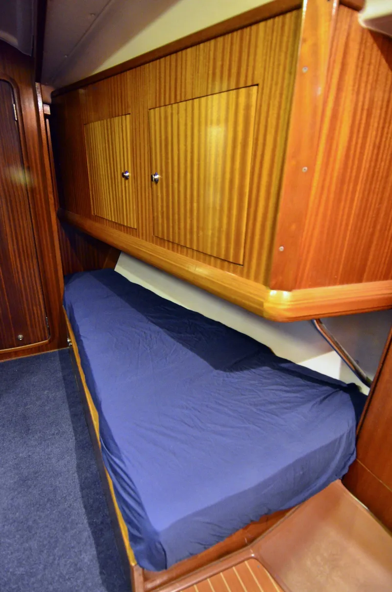 Slide: The Image of Interior cabin of 2003 Bavaria 49 yacht with wooden finish and blue bedding. - 12