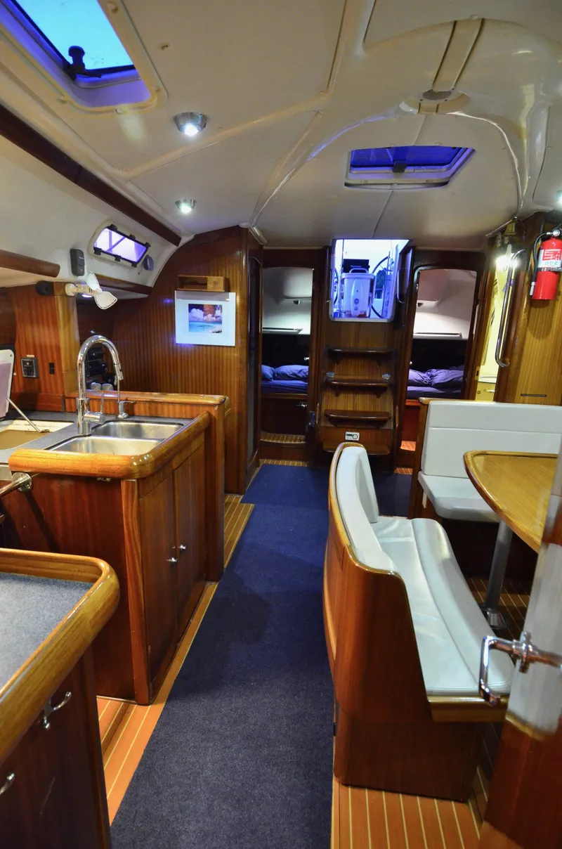 Slide: The Image of Interior of a 2003 Bavaria 49 yacht with wooden finishes and modern amenities. - 16