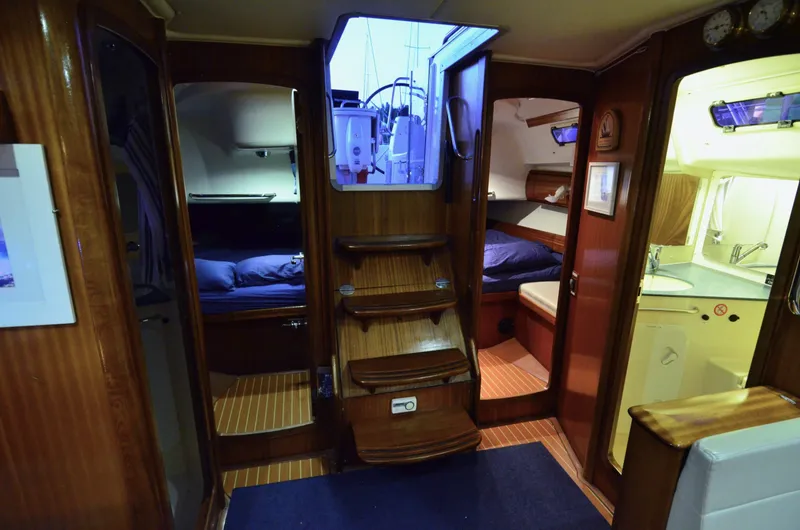 Slide: The Image of Interior of a 2003 Bavaria 49 yacht, featuring cozy cabins and a compact kitchen area. - 17