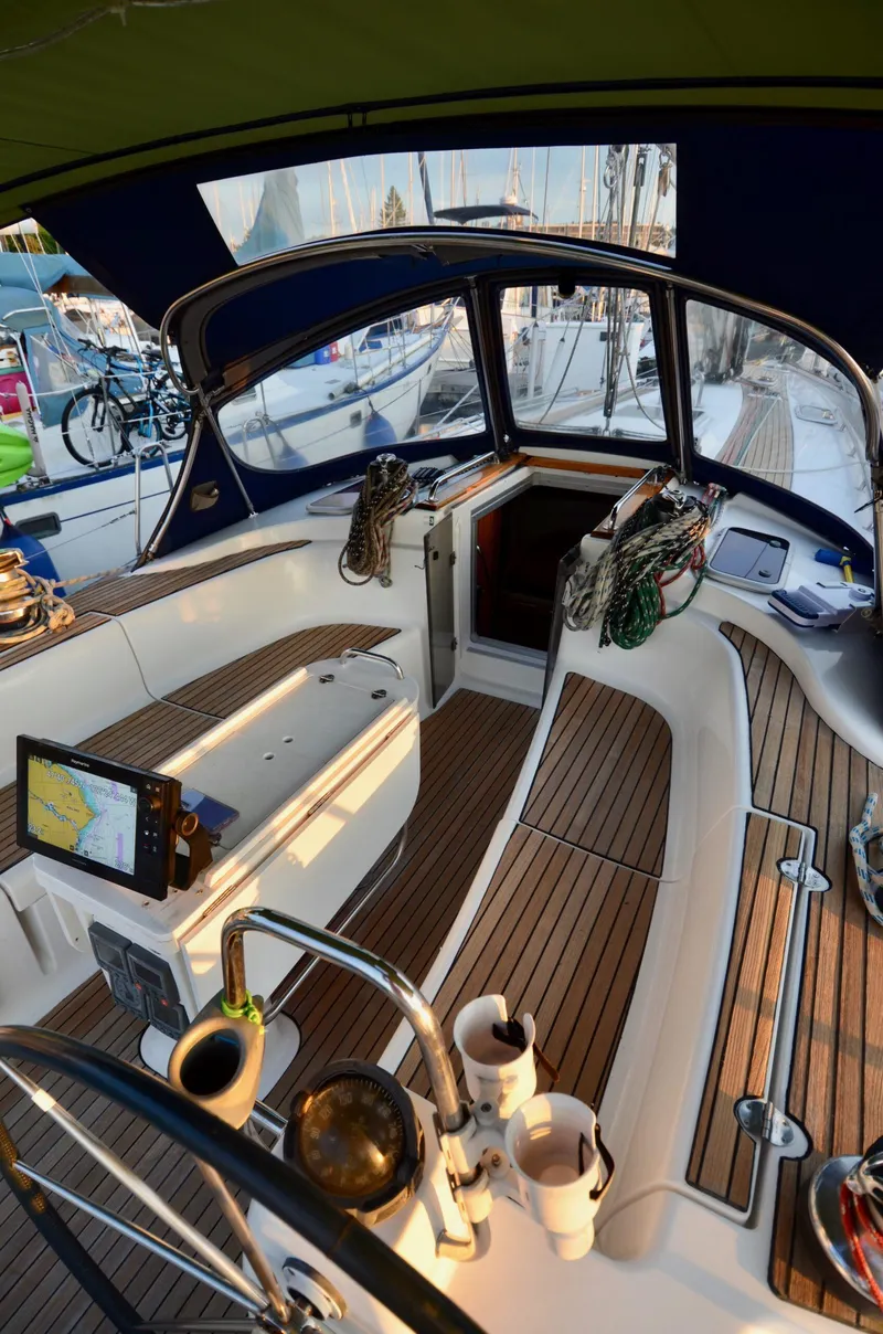 Slide: The Image of Cockpit of 2003 Bavaria 49 sailboat with wooden flooring and navigation equipment. - 18