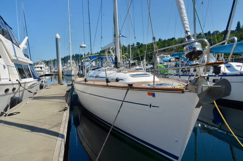 Slide: The Image of 2003 Bavaria 49 sailboat docked at a marina on a sunny day. - 24