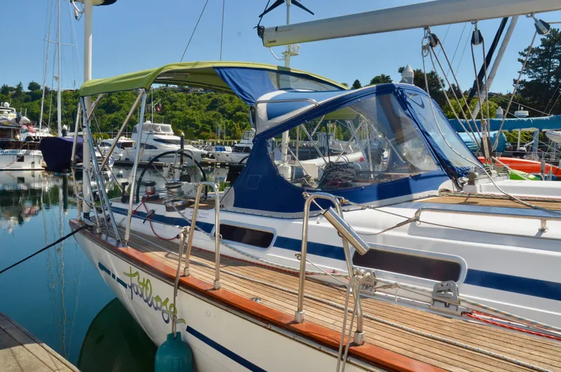 Slide: The Image of 2003 Bavaria 49 sailboat docked in a marina with green and blue canopy. - 26