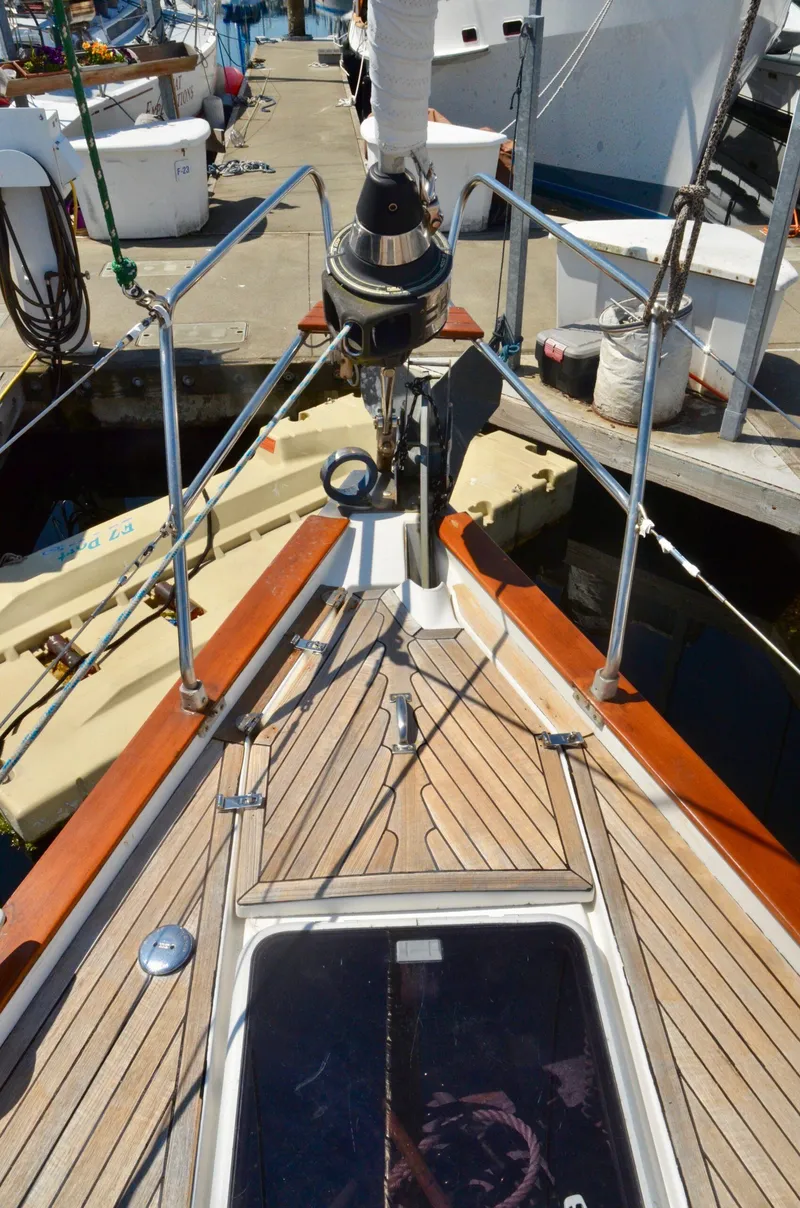 Slide: The Image of Bavaria 49 sailboat deck, 2003 model, docked at marina with wooden finish and rigging. - 28