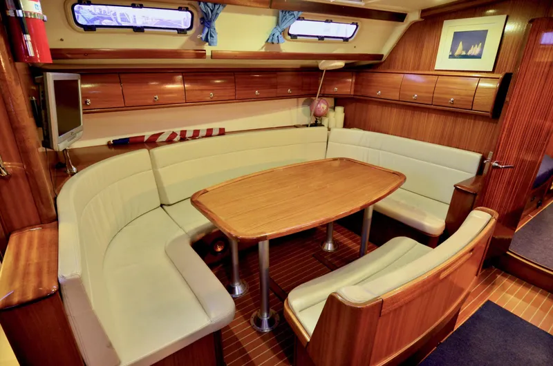 Slide: The Image of Interior of 2003 Bavaria 49 yacht with cozy seating and wooden finishes. - 3