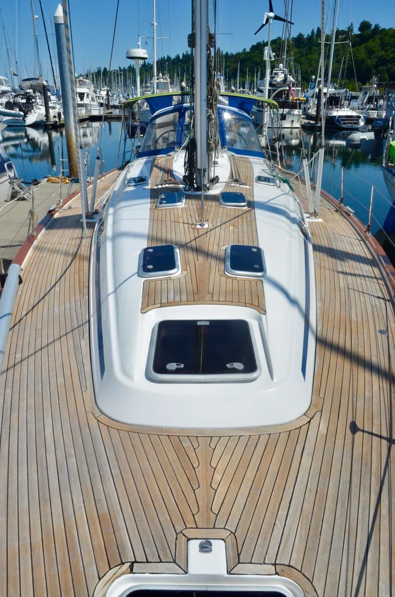 Slide: The Image of 2003 Bavaria 49 sailboat with teak deck, docked in a marina. - 31