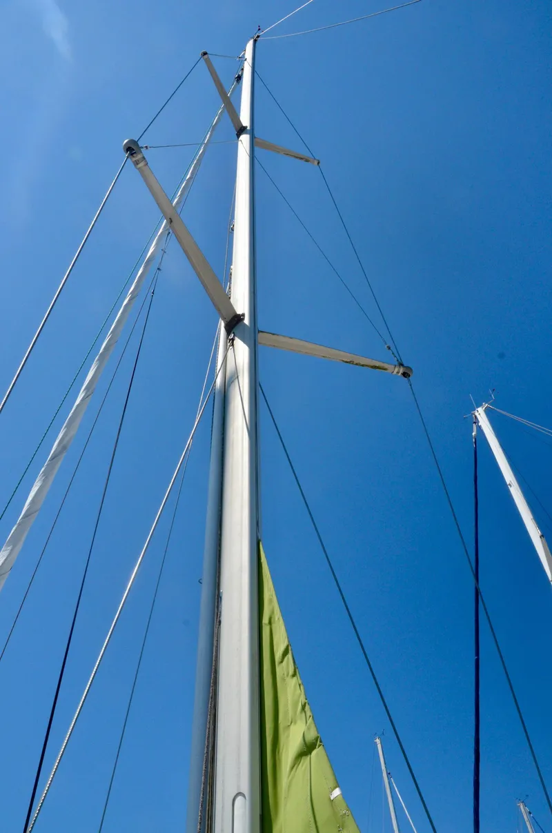 Slide: The Image of Mast of a 2003 Bavaria 49 sailboat against a clear blue sky. - 38