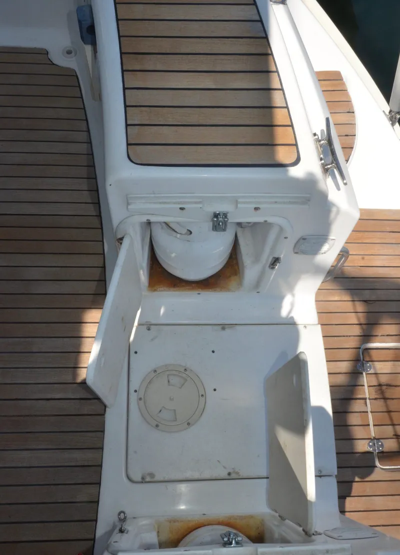 Slide: The Image of Bavaria 49 yacht deck, 2003 model, featuring wooden flooring and storage compartments. - 44