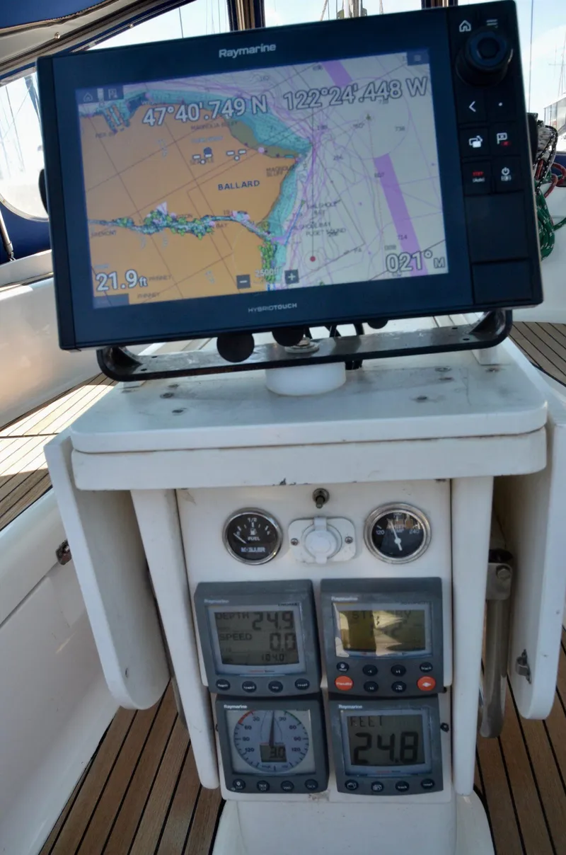 Slide: The Image of Navigation equipment on a 2003 Bavaria 49 sailboat, featuring GPS and control panels. - 48