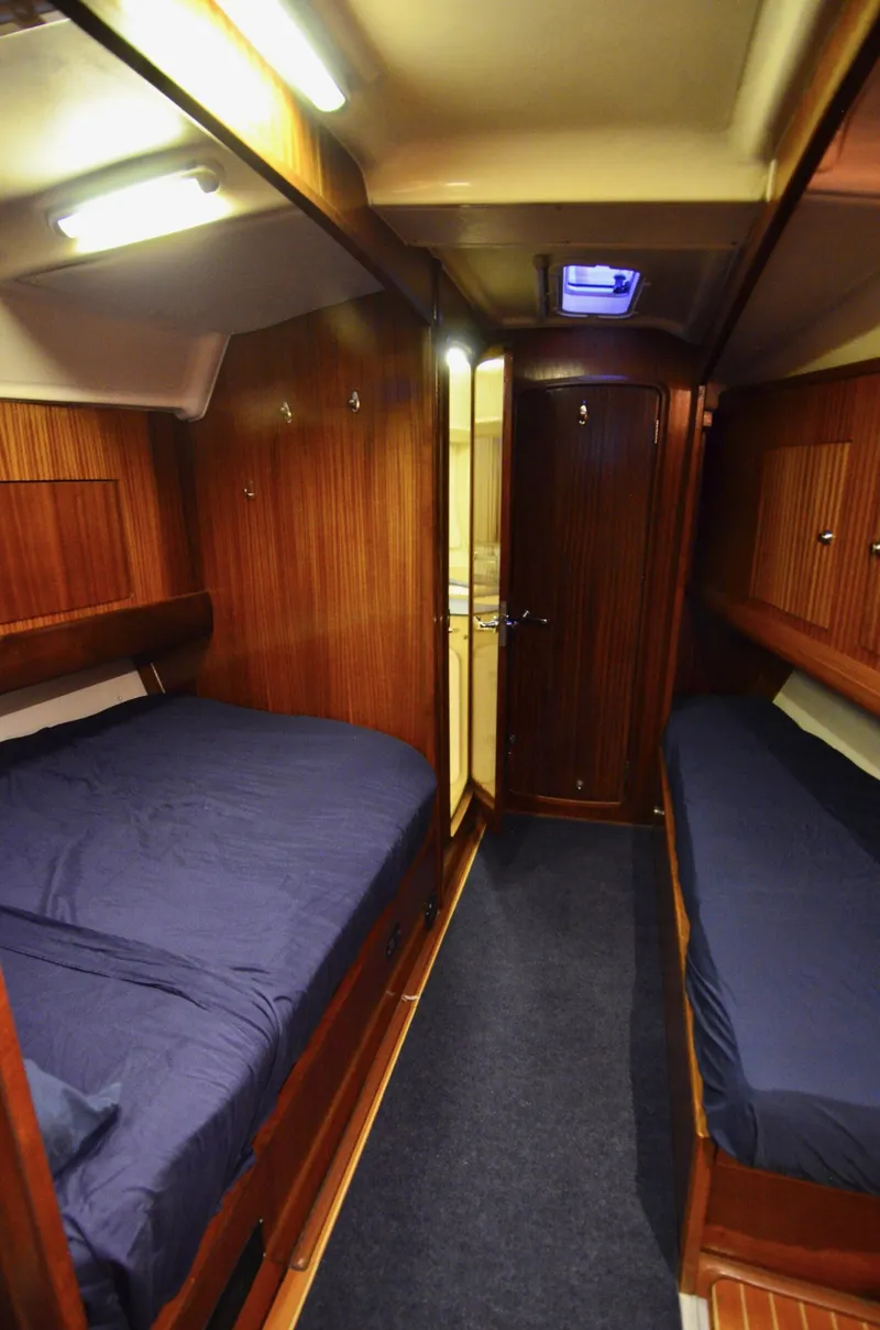 Slide: The Image of Interior cabin of 2003 Bavaria 49 yacht with twin beds and wooden finish. - 9
