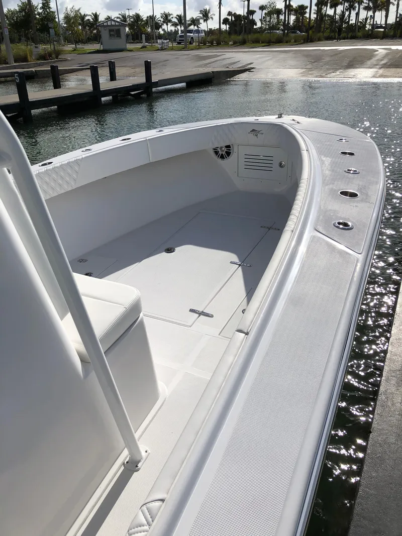 Slide: The Image of 2021 Ocean Runner 2900 CC boat docked at marina, showcasing spacious deck and seating. - 10