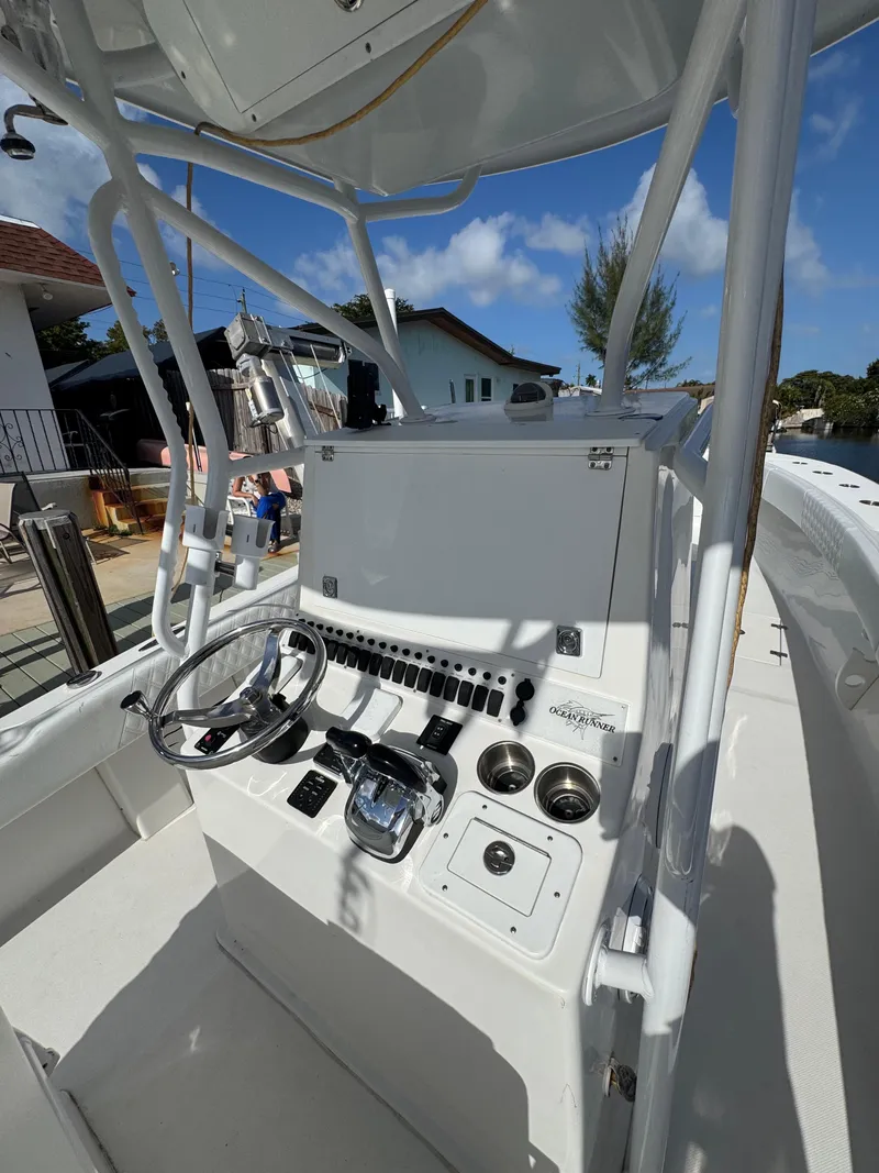 Slide: The Image of 2021 Ocean Runner 2900 CC boat console with steering wheel and controls. - 11