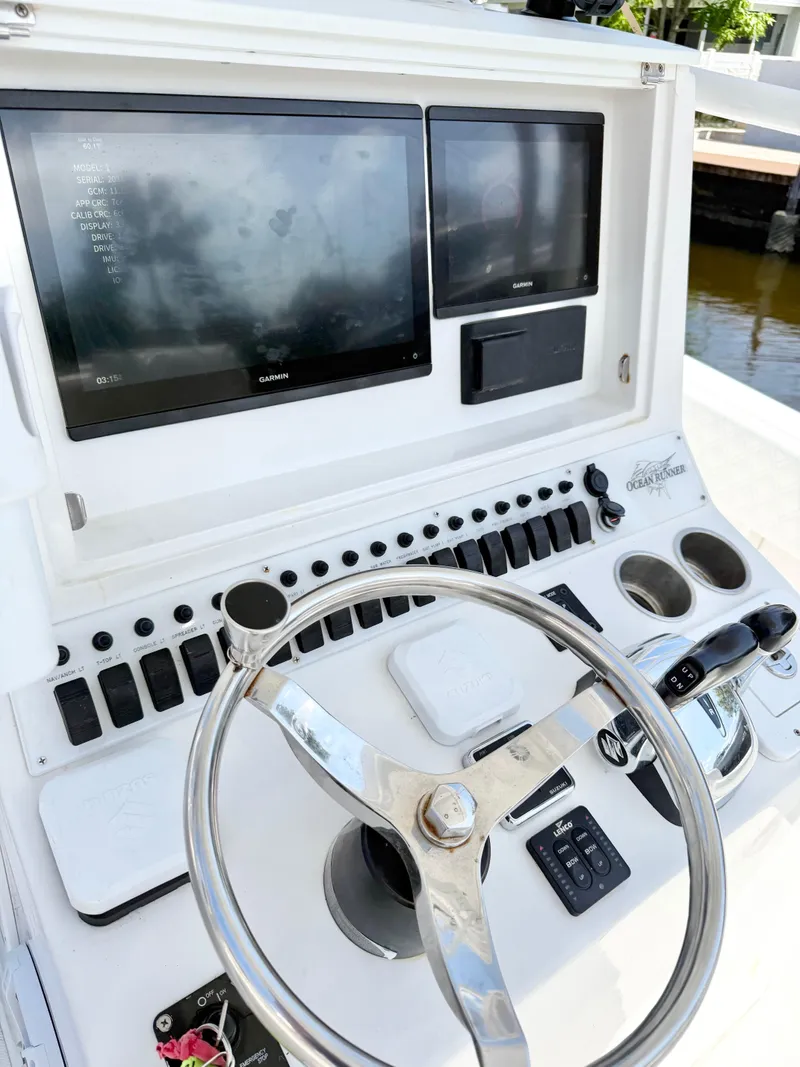 Slide: The Image of Control panel of a 2021 Ocean Runner 2900 CC boat with Garmin displays. - 12