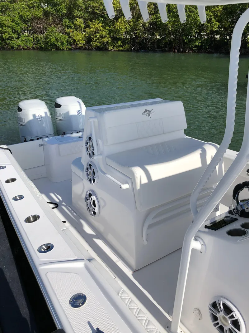 Slide: The Image of 2021 Ocean Runner 2900 CC boat with dual Suzuki engines, white seating, and speaker system. - 16