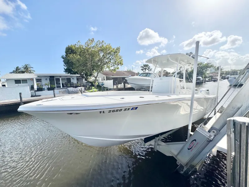 Slide: The Image of 2021 Ocean Runner 2900 CC boat docked in a sunny marina setting. - 2