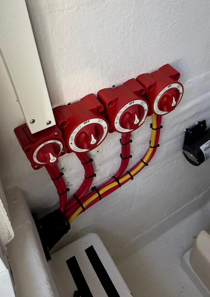 Slide: The Image of Red electrical switches and wiring in a 2021 Ocean Runner 2900 CC boat. - 20